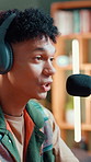 Microphone, headphones and man in studio for recording podcast, broadcast or live streaming. Audio tech, talking and male influencer with equipment for hosting platform, radio station or web channel.