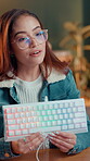 Keyboard, streamer and review with woman in studio for gamer channel, sponsorship and tech guide. Product influencer, gaming equipment and promotion with person in home for recording and social media