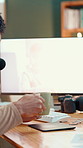 Hands, computer screen and coffee for video editing, project and process for podcast in studio. Person, content creation and monitor for show, display and drink with tea cup for social media in home
