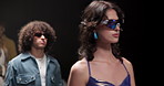Fashion, catwalk and walking with model at runway event for designer collection, clothing showcase and couture. Fabric, wardrobe and luxury show with people on stage for trendy, and style industry