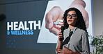 Business woman, presentation and health seminar with mic for wellness speech or awareness campaign. Female person, presenter or speaker for healthcare talkshow, medical convention or staff workshop