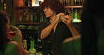 Women, bartender and mixing drinks at a pub for customer, martini or happy hour at counter. Man, mixologist and people with alcohol beverage at bar or nightclub for drinking, social event and party