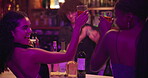 Cheers, drinking and woman friends at bar together for celebration, clubbing or social gathering. Party, smile and toast with happy people in pub or tavern at night for event, milestone or reunion