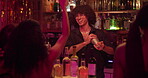 Bartender, women and mixing drinks at a club for customer, cocktail or happy hour at counter. Man, mixologist and people with alcohol beverage at bar or pub for cheers, social event and party