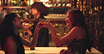 Women, friends and cheers alcohol at nightclub for celebration, fun and reunion for night out. People, laugh and toast drinks for happy hour, social event and bonding together at party for clubbing