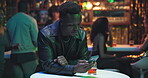 Man, waiting and typing with phone at club of date delay, texting and frustration with alcohol. Male person, stood up and mobile for chatting, message contact and online distraction for lonely at pub