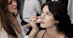 Makeup artist, backstage and blush with women in studio for cosmetics, fashion and makeover. Stylist, beautician and behind the scenes with people for foundation routine, model touch up and talent