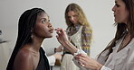 Woman, model and beautician for makeup, photoshoot or fashion interview in studio. Behind the scenes, stylist and artist touch up in media agency with designer, cosmetology and creative industry