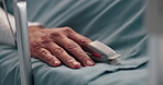 Hand, healthcare and oximeter with person in hospital bed for monitoring, recovery or treatment. Finger, heart rate and rest with patient in clinic for medical operation, procedure or surgery closeup