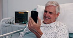 Hospital, bed and old man with smartphone for video call, talking or contact for emotional support. Healthcare, male person and senior patient with mobile for recovery update, wellness and happiness