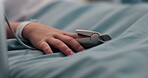 Finger, healthcare and oximeter with person in hospital bed for monitoring, recovery or treatment. Hand, heart rate and rest with patient in clinic for medical operation, procedure or surgery closeup