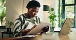 Woman, remote work and reading clipboard for finance, accounting or budget. Document, home and serious African freelancer with report for tax invoice, bookkeeping and check audit review on checklist