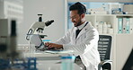Typing, research and laptop with man in laboratory for forensic, toxicology report and science. Medical analysis, pathology screening and tissue sample with person in clinic for investigation