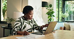 Black woman, writing notes and laptop for remote work, accounting and financial metrics. Computer, home and freelancer with document for tax invoice, bookkeeping and  typing report for audit review