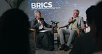 Conference, interview and speech with business people on stage in auditorium for BRICS seminar. Discussion, education and update with speakers on podium for lecture on emerging economies cooperation