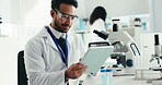 Man, scientist and typing on tablet in lab for research, medical study and online results. Male person, microscope and checklist for experiment, review feedback and discovery report for vaccine trial