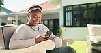 Smile, black woman and reading with phone at house for browsing internet, social media and weekend. Happy, female person and mobile for downloading ebook, streaming movie and funny videos in backyard