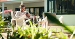 Phone, outdoor and black woman in backyard for social media, relax and break on weekend by home. Smile, reading and African person with technology, internet message or story in garden with text