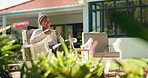 Coffee, outdoor and black woman relax in backyard for calm, peace and break on weekend by home. Smile, thinking and female African person with cappuccino, latte or espresso in garden with drink