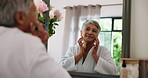Mature woman, spa and mirror with skincare for moisturizer or face cream at beauty salon. Senior, female person or smile with reflection or lotion in robe for facial skin treatment at luxury resort