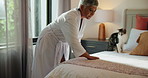Woman, making bed and cleaning in home with cat, routine or morning for fresh sheets, tidy or chores. Mature person, blanket and start day in bedroom with pet, animal and duvet for comfort in house