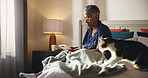Mature woman, writing and notepad in bed for dream, reflection and reminder with cat at apartment. Person, notes and start morning with journal, planning and book with pet, animal and inspiration