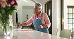 Mature woman, cleaning and cloth with dirt on table for housekeeping or chores at home. Female person, fabric and wiping surface with dust, litter or rubbish for bacteria or germ removal at house