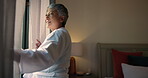 Curtains, morning and wake up with old woman in hotel room for accommodation or hospitality. Retirement, smile and window with happy senior person at lodge or resort for holiday, travel and vacation