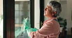Cleaning, window and mature woman with cloth for hygiene, housekeeping and maid service. Washing, glass and person with spray bottle, detergents and liquid for bacteria, disinfection and dust in home