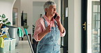 Mature woman, phone call and home with cleaning, angry and shout with conflict on mobile network. Person, smartphone and hygiene routine with stress, contact and fight with argument at apartment
