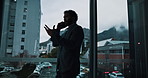 Business, phone call and window with man in office for morning conversation or negotiation. Communication, discussion and explain with corporate employee at work in city for project management