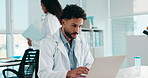 Serious, scientist and man with laptop, lab or medical research on website, biotechnology or online. Clinic, researcher and person with tech for project, typing and article for science and healthcare