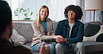 Happy, couple and holding hands for consultation, therapy and discussion for pre marital counseling. Psychologist, advice and communication skills for relationship, smile and listening in office