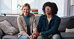 Happy, couple and holding hands for therapy, talking and laughing in office, smile and consultation. Appointment, man and woman with trust on sofa, relationship or services for pre marital counseling