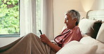 Phone, smile and senior woman in bed with social media, comic or comedy video on the internet. Happy, technology and mature female person in scroll on mobile app with cellphone in home for break