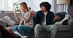 Therapy, argument and couple on sofa with psychologist for relationship conflict or infidelity. Upset, fighting and man with woman at therapist office for marriage counseling session for cheating.