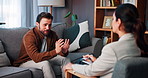 Counseling, stress and man with therapist on sofa for consulting, emotional support and help. Psychology, mental health and person with patient talking for therapy session, diagnosis or evaluation
