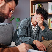 Therapy, writing and man crying on sofa for help, counseling session ...