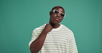 Black man, fashion or sunglasses with confidence for style or swag on a green studio background. Portrait, male person or serious African model with pop collar, shades or eyewear on mockup space