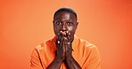 Face, surprise and black man in studio, wow and announcement on orange background. African person, portrait and model with confidence, omg and winner with discount deal, secret and emoji with shock