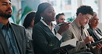 Woman, listen and happy with notebook at convention for training, presentation or review at company. People, employees and smile with attention, notes and insight with point at financial conference