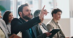 Businessman, raised hand and question in crowd at convention for pitch, notebook and presentation. People, employee and talk in audience with discussion, writing and feedback at finance conference