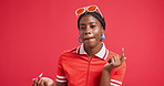 Face, lip gloss and black woman in studio, makeup and cosmetics on red background. African person, portrait and model with skincare, dermatology and shine with glow, confidence and application