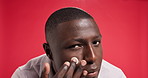 Cream, skincare and face of black man with jar for skin hydration, wellness and facial care. Dermatology, studio and portrait of person with moisturizer, lotion and creme for health on red background