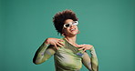 Happy, black woman and fashion with style in studio for clothing or outfit on green background. Female person, model or smile with sunglasses in stylish garment for glamour or swag on mockup space