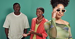 Fashion, gossip and sunglasses with fans of influencer on green background for celebrity fame. Confident, excited and shades on content creator with followers in studio for hearsay or rumors