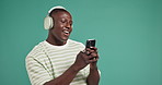 Black man, smartphone or happy dance on green background with music, space or smile. Good mood, song choice and excited model with mobile app in studio with rhythm, positive energy or streaming sound