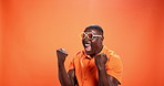 Black man, winner and happy with fist pump in studio with sunglasses, fashion or sale by background. African person, smile and yes with cheers, trendy style or goals with mockup space for celebration
