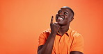 Happy, black man or thinking with idea in studio for choice or decision on a orange background. Male person, African model or wonder with smile in thought, solution or problem solving on mockup space