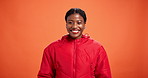 Face, cool and happy black woman with fashion in studio for trendy outfit, jacket or confidence. Model, positive or female person on orange background with proud smile, red clothes or casual style